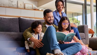 Indian family reading a book together