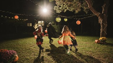 Children running in costumes trick or treating